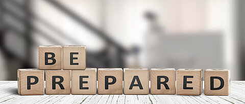 Be prepared phrase on wooden dices in a bright room on an old desk